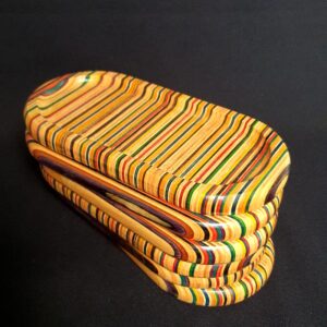 photo of a stack of small trinket trays made out of recycled skateboards