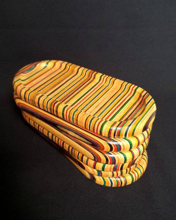 photo of a stack of small trinket trays made out of recycled skateboards